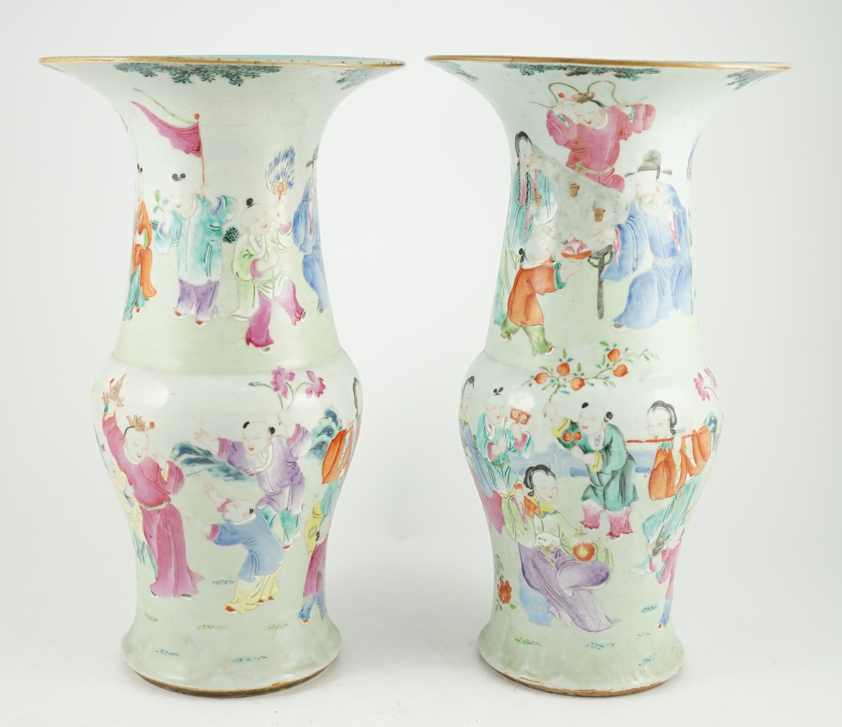 A pair of Chinese famille rose fencai ‘boys’ baluster vases, 19th century, 39.7 and 40cm high, hairline cracks